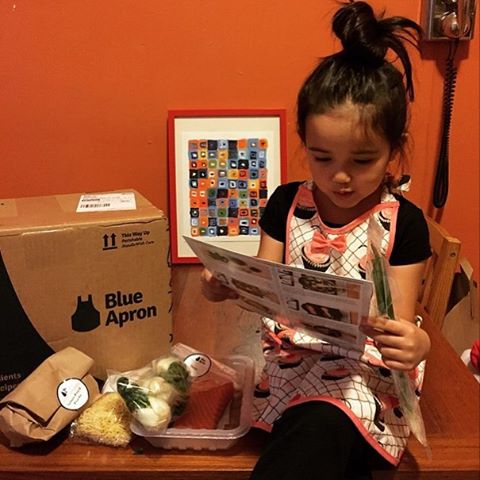 a child reading instruction she got from the blue apron box