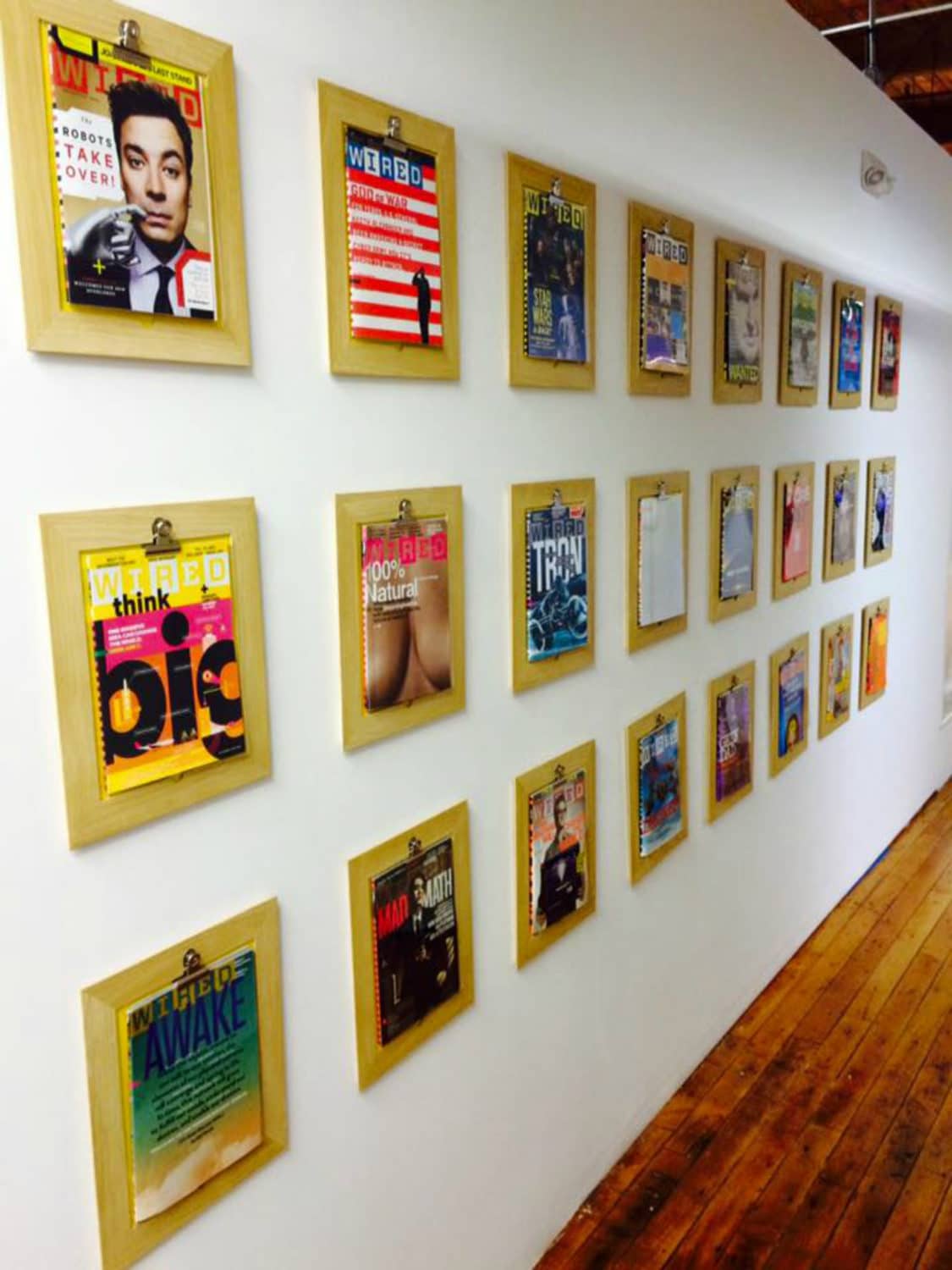 magazine covers on the wall at industry charlotte