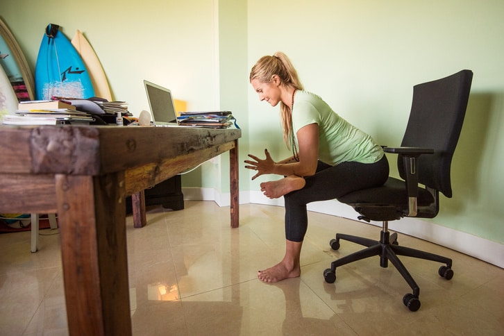 a lady doing some yoga at work