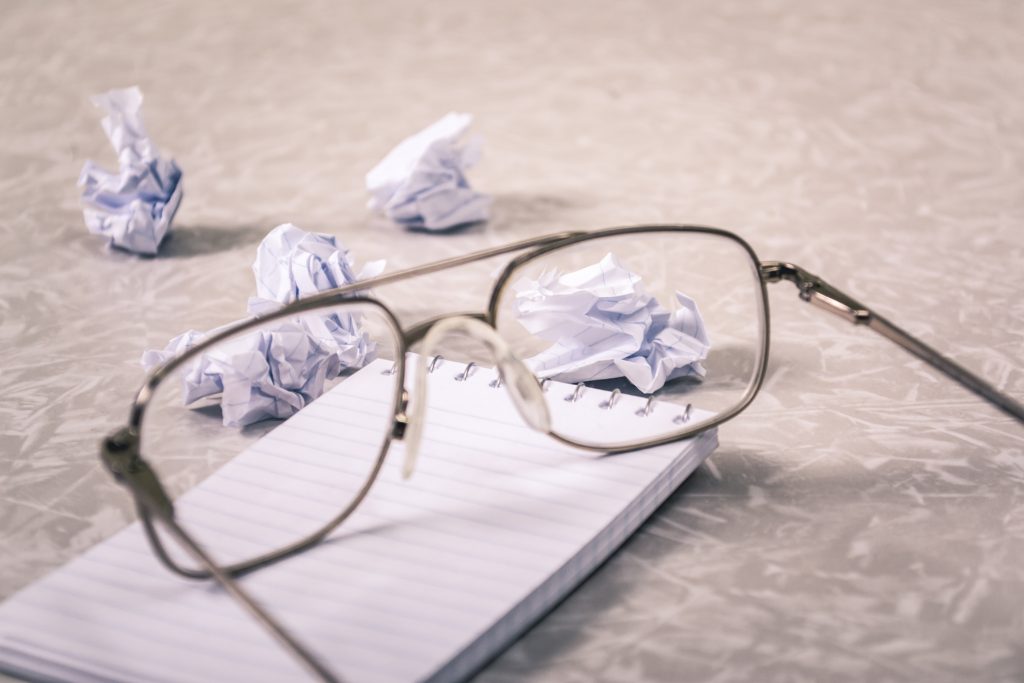 eyeglasses placed on top of a notepad