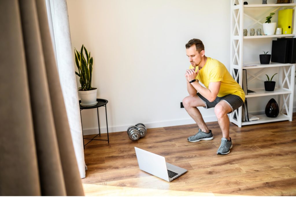 man doing a virtual workout at home