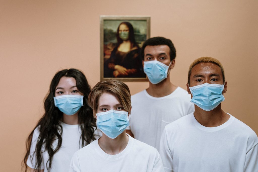 People of different races wearing a surgical mask