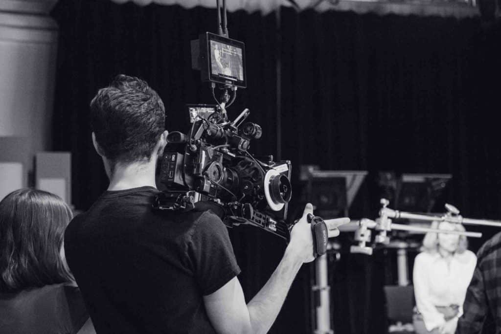 A monochrome photograph showcasing people interacting in a room environment.