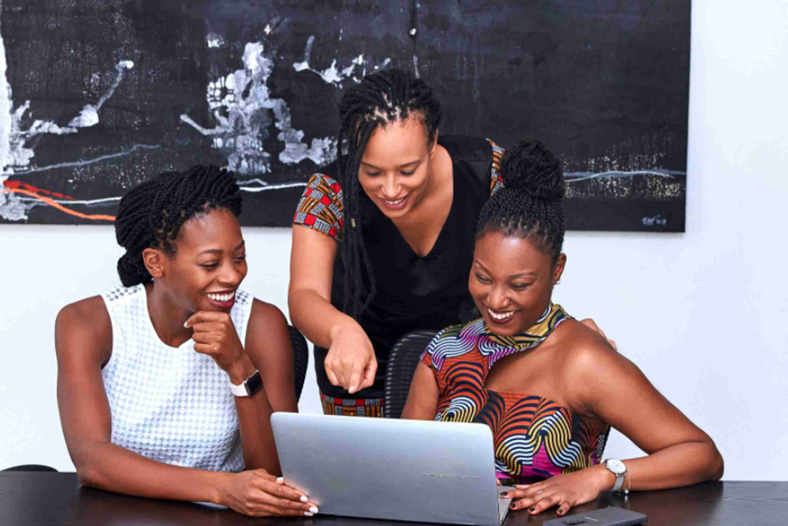 three woman looking at laptop screen 4