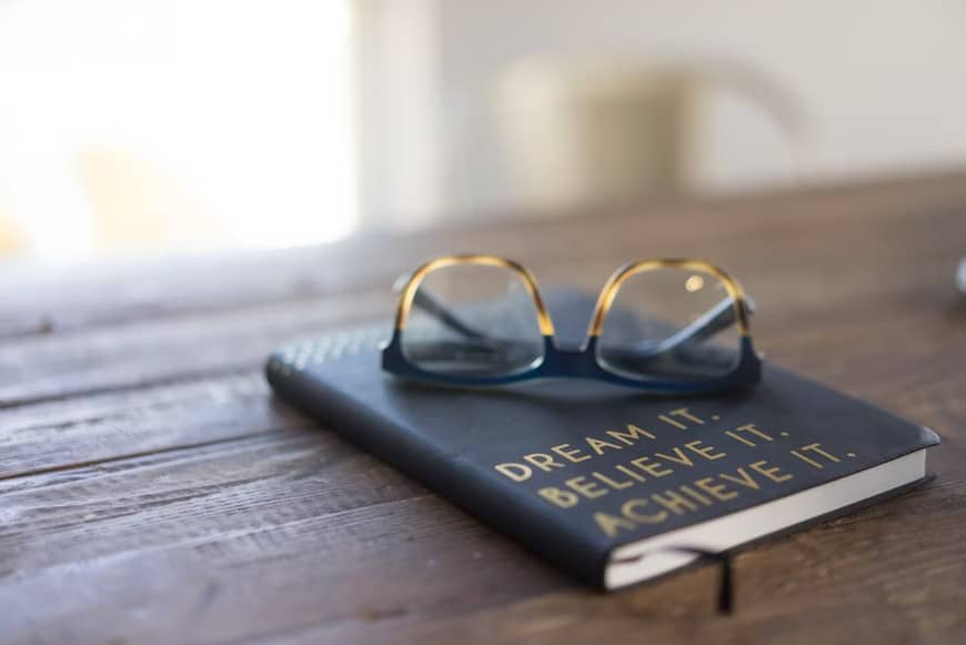 glasses on top of a journal