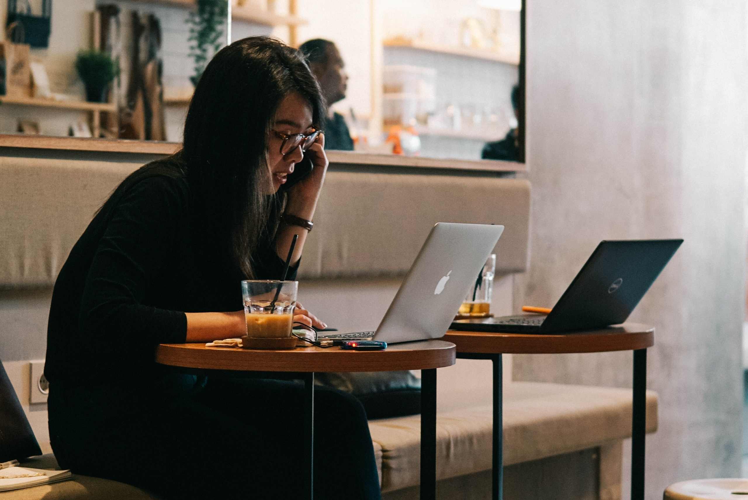 woman on her phone while working in a coworking space