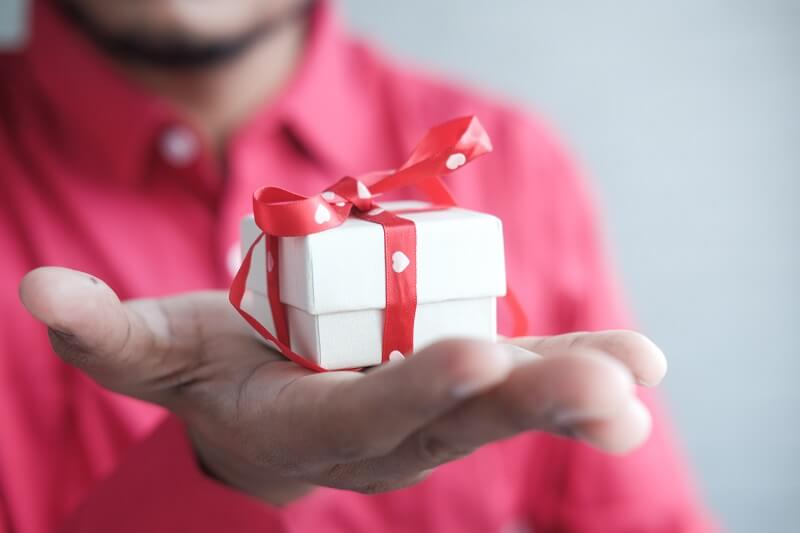 man holding small gift 1