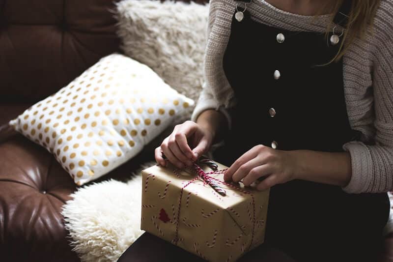 woman opening a gift sent via a digital mailbox
