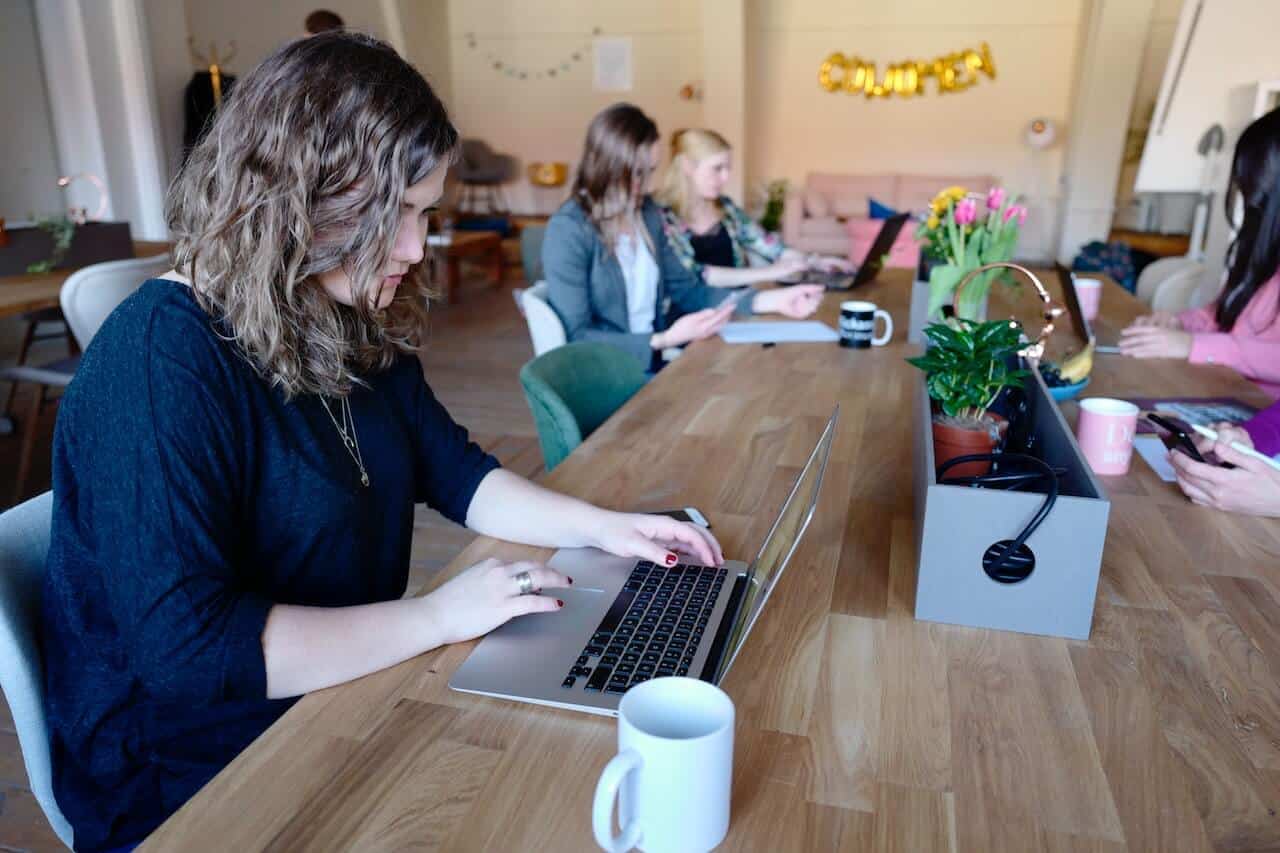 photograph of professional women working at one of many types of NYC coworking spaces