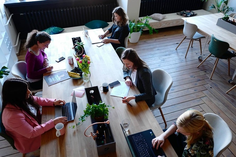 photograph of professional women making use of a niche shared workspace 